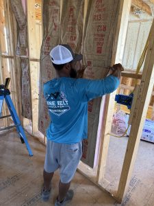 laying Batt insulation in new home construction in Hattiesburg, ms