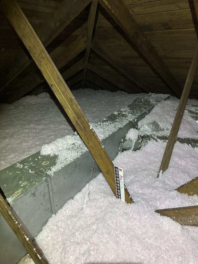 Insulation removal and replacement in an attic 